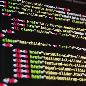 Close-up of HTML code highlighted in vibrant colors on a computer monitor.